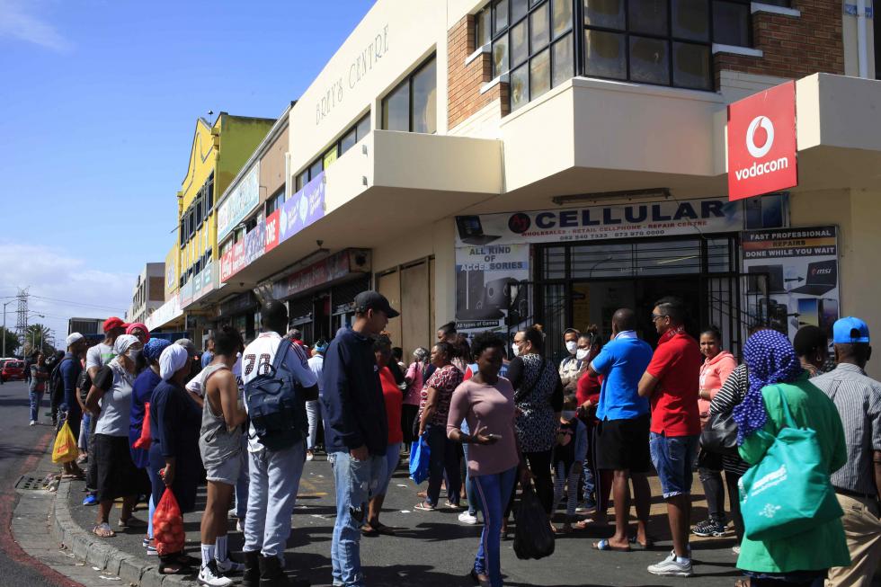 People queuing in the Cape Flats, Cape Town People queuing in the Cape Flats, Cape Town