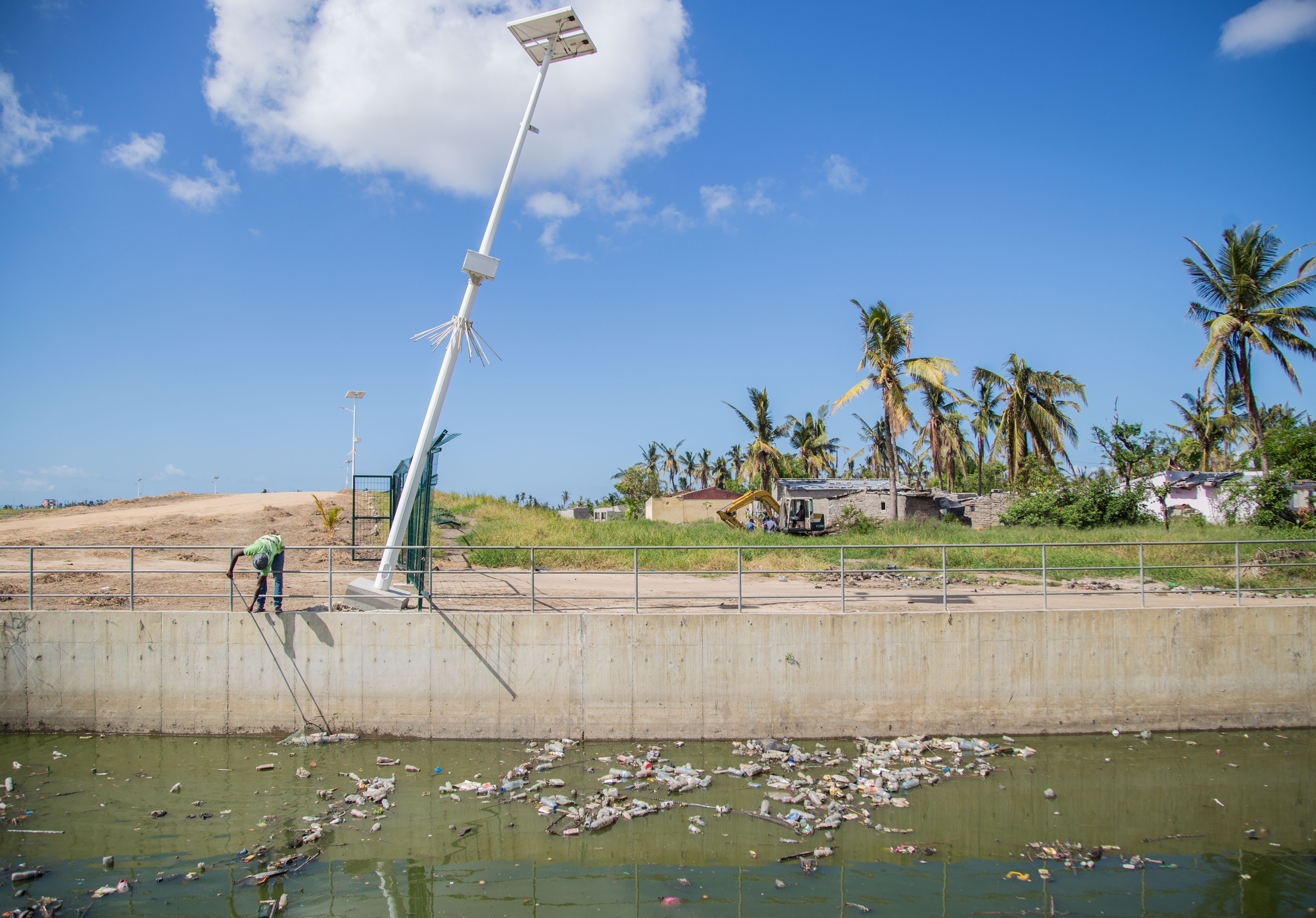 Municipal worker cleans canals that reduce the risk of flooding in Beira Municipal worker cleans canals that reduce the risk of flooding in Beira