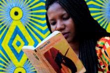 Woman reading Une si longue lettre, Mariama Bâ’s award-wining 1979 feminist novel. Photo courtesy of Tenin Samake.