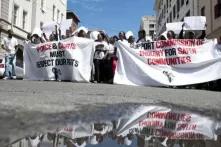 Members of the Social Justice Coalition protest outside the High Court in Cape Town, South Africa.