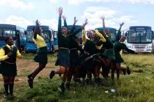 Learners celebrating after buses and taxis arrive at their school.