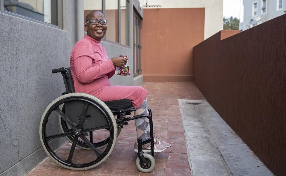 It’s a sunny day and wheelchair user Makgosi Letimile sits behind the wall that separates her building from Trill Road, Observatory. This is the only place she has easy access to in her neighbourhood.