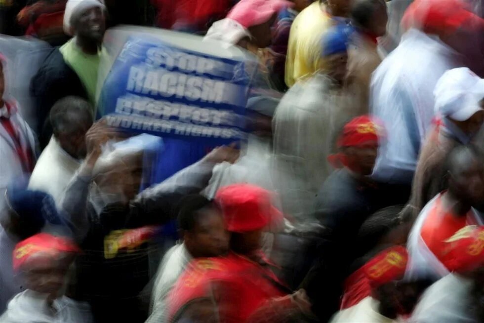 blurred image asking for the ending of racism