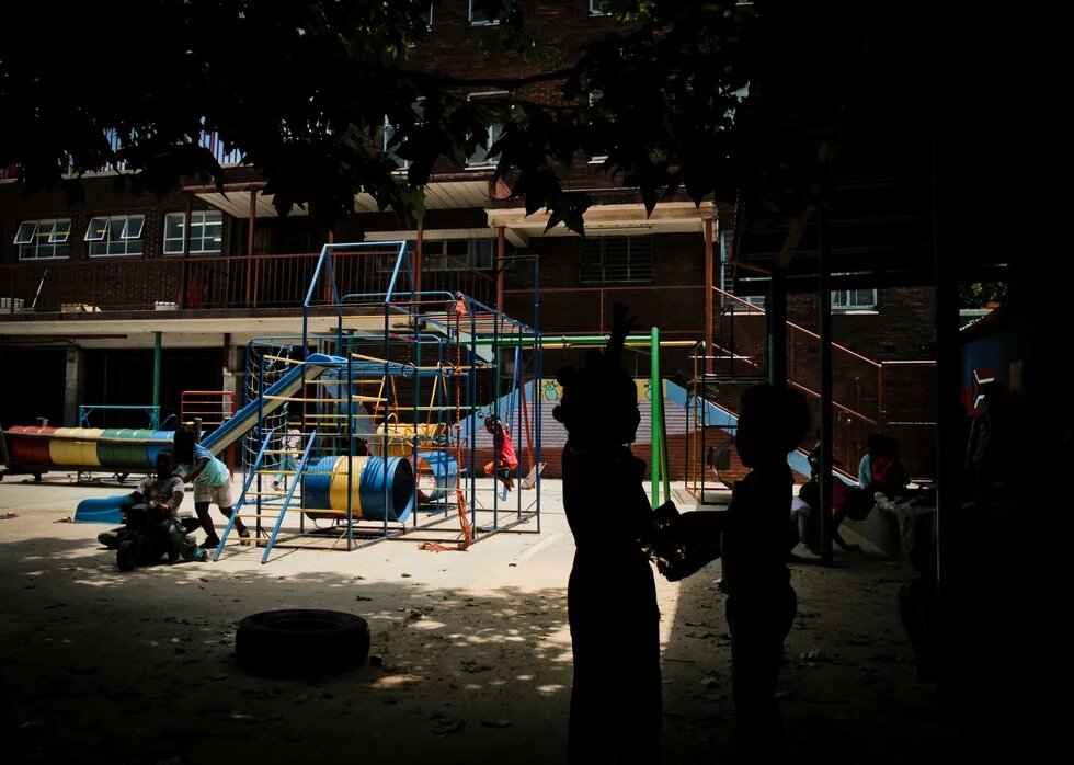 Children playing outside a shelter for abused women and children