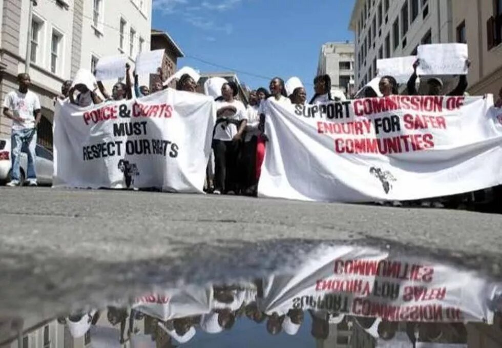 Members of the Social Justice Coalition protest outside the High Court in Cape Town, South Africa. Members of the Social Justice Coalition protest outside the High Court in Cape Town, South Africa.