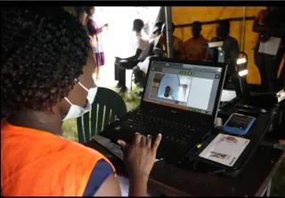 A Zimbabwean election official enters details of a woman who had come to register to vote on the outskirts of Harare A Zimbabwean election official enters details of a woman who had come to register to vote on the outskirts of Harare